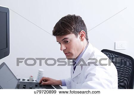 Stock Photo - Doctor doing a doppler sonography. Fotosearch