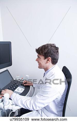 Doctor doing a doppler sonography View Large Photo Image Stock Photo - Doctor doing a doppler sonography. Fotosearch