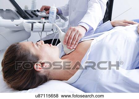 Stock Photo - Doctor doing a doppler sonography. Fotosearch