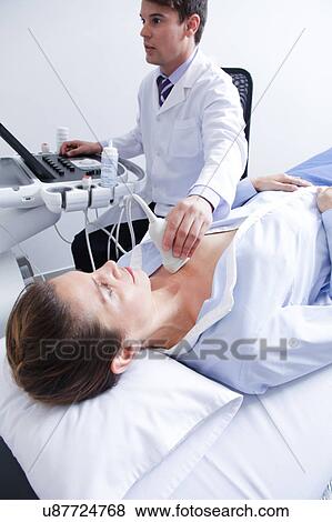 Doctor doing a doppler sonography View Large Photo Image Stock Photo - Doctor doing a doppler sonography. Fotosearch
