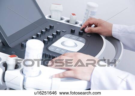 Stock Photograph - Doctor doing a doppler sonography. Fotosearch