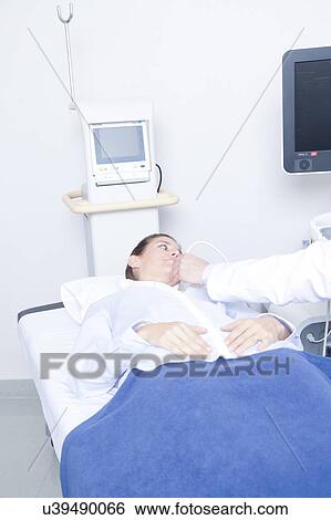Stock Photograph - Doctor doing a doppler sonography. Fotosearch