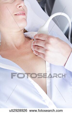 Stock Photograph - Doctor doing a doppler sonography. Fotosearch