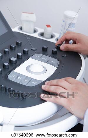 Stock Photograph - Doctor doing a doppler sonography. Fotosearch