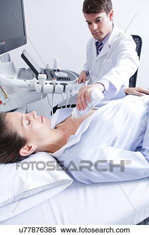 Stock Photography - Doctor doing a doppler sonography. Fotosearch