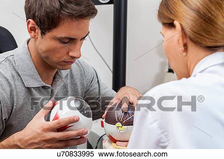 Stock Photography - Doctor explaining to the patient about the eye. Fotosearch