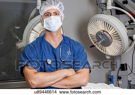 Picture - Doctor idly and looking at camera. Fotosearch