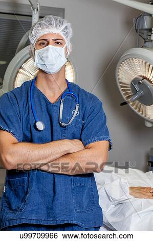 Doctor idly and looking at camera View Large Photo Image Stock Photograph - Doctor idly and looking at camera. Fotosearch