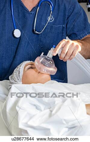 Doctor putting oxygen tube View Large Photo Image Picture - Doctor putting oxygen tube. Fotosearch