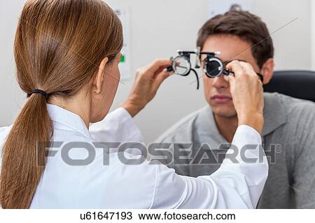 Doctor putting special lenses View Large Photo Image Stock Image - Doctor putting special lenses. Fotosearch