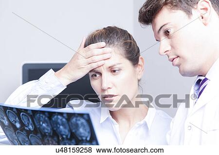 Stock Photo - Doctor with a patient. Fotosearch