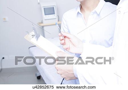 Stock Photography - Doctor with a patient. Fotosearch