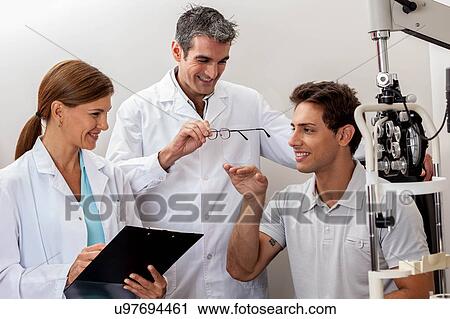 Doctors showing the glasses View Large Photo Image Stock Image - Doctors showing the glasses. Fotosearch