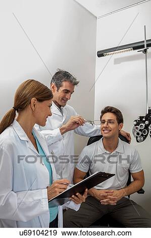 Stock Photo - Doctors showing the glasses. Fotosearch