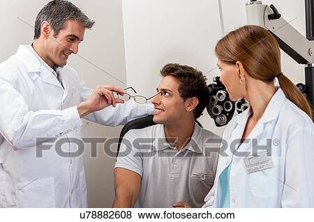 Doctors showing the glasses View Large Photo Image Stock Photo - Doctors showing the glasses. Fotosearch
