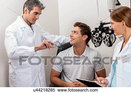 Doctors showing the glasses View Large Photo Image Stock Photography - Doctors showing the glasses. Fotosearch