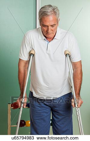 elder man using a crutches View Large Photo Image Stock Image - elder man using a crutches. Fotosearch