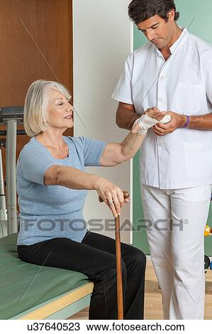 Stock Image - elder woman and his doctor . Fotosearch