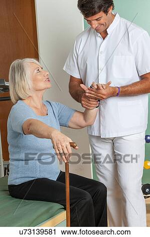 Stock Image - elder woman and his doctor . Fotosearch