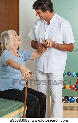 Stock Photo - Elder woman and his doctor . Fotosearch