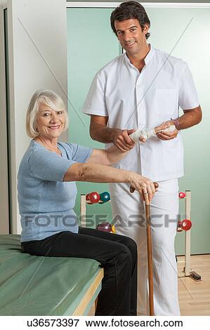 Stock Photo - elder woman and his doctor . Fotosearch