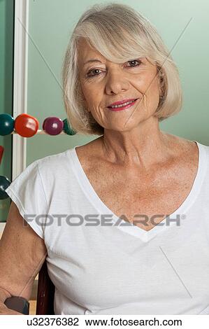 Stock Image - Elder woman in a wheelchair. Fotosearch