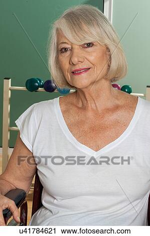 Elder woman in a wheelchair View Large Photo Image Stock Image - Elder woman in a wheelchair. Fotosearch