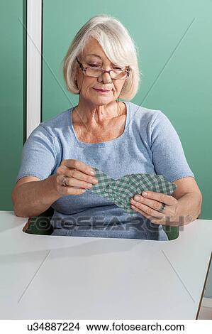 Picture - Elder Woman playing cards. Fotosearch