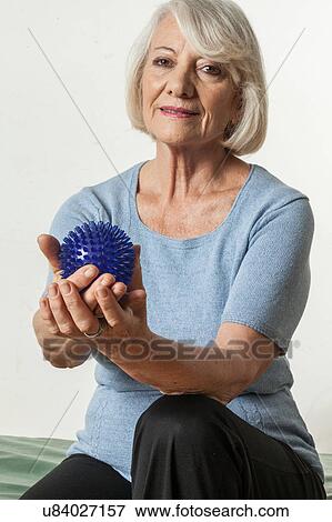 Stock Photo - Elderly Woman who rehabilitates his hand. Fotosearch