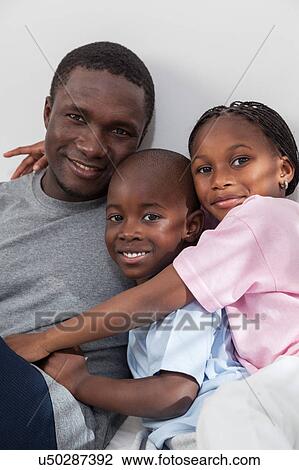 Stock Image - Family in the bed. Fotosearch