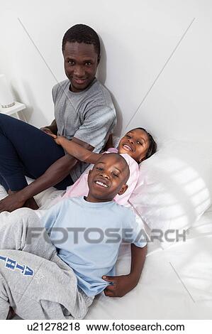 Stock Photo - Family in the bed. Fotosearch
