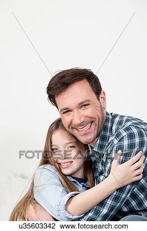 Stock Image - Father and daughter giving himself a hug. Fotosearch