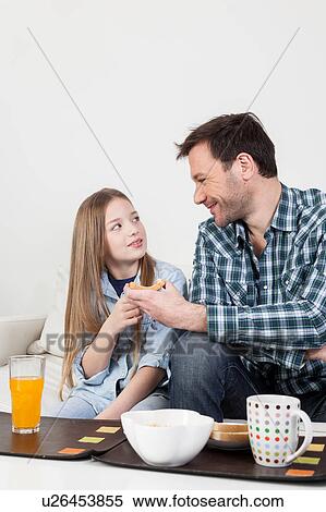 Father having a breakfast with his daughter View Large Photo Image Stock Photography - Father having a breakfast with his daughter. Fotosearch