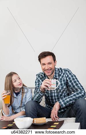 Father with his daughter having a brakfast View Large Photo Image Stock Image - Father with his daughter having a brakfast. Fotosearch