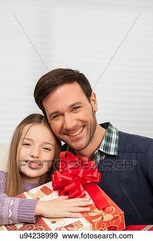 Father with his daughter smiling sitting together View Large Photo Image Stock Photo - Father with his daughter smiling sitting together. Fotosearch