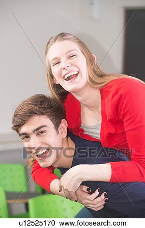 Stock Image - Friends having fun in the college. Fotosearch