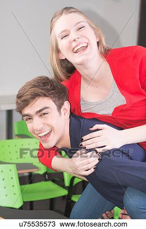 Stock Image - Friends having fun in the college. Fotosearch