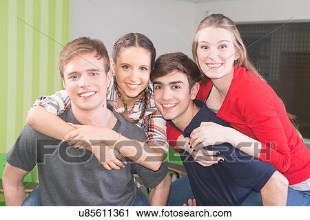 Stock Image - Friends having fun in the college. Fotosearch