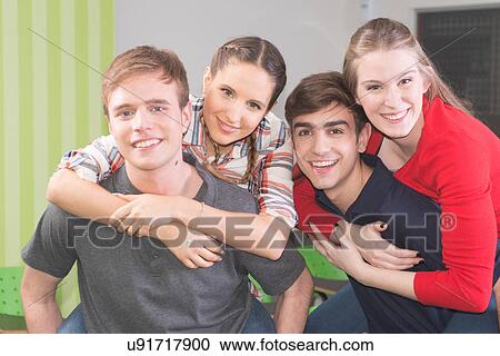 Stock Image - Friends having fun in the college. Fotosearch