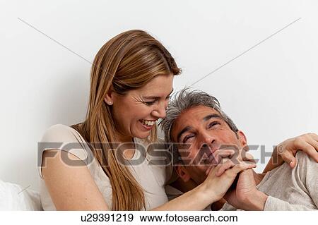 Stock Photo - Fun couple in the bed. Fotosearch