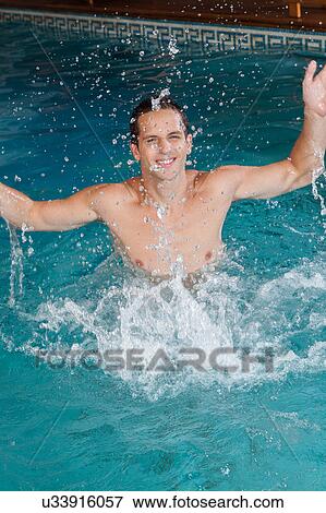 Stock Photo - Funny man playing in the pool. Fotosearch