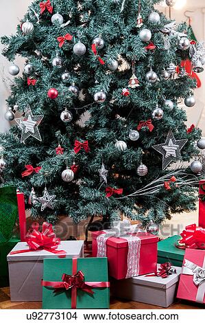 Gifts beside christmas tree View Large Photo Image Picture - Gifts beside christmas tree. Fotosearch