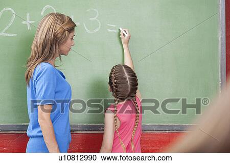 Stock Image - Girl doing an excercise of math. Fotosearch
