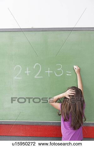 Stock Image - Girl doing an excercise of math. Fotosearch