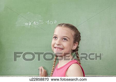 Stock Image - Girl doing an excercise of math. Fotosearch