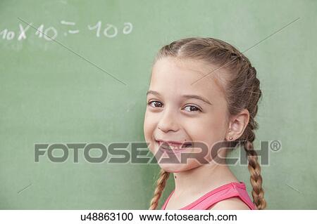Stock Image - Girl doing an excercise of math. Fotosearch