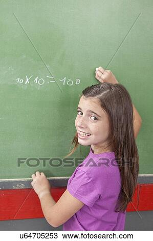 Stock Image - Girl doing an excercise of math. Fotosearch