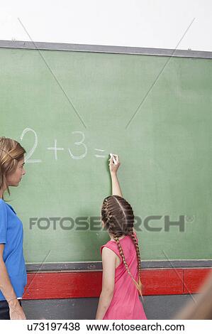 Stock Photo - Girl doing an excercise of math. Fotosearch