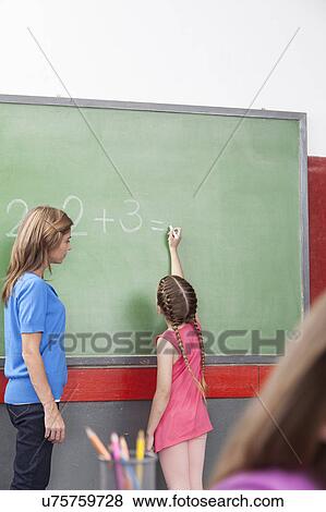 Stock Photo - Girl doing an excercise of math. Fotosearch