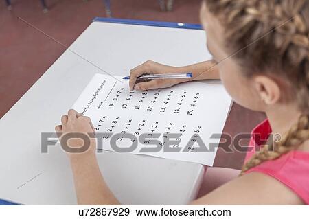 Stock Photo - Girl doing the exam. Fotosearch